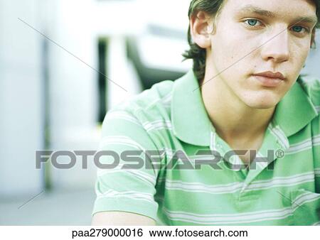 Young man, looking at camera, portrait View Large Photo Image Stock Photograph - Young man, looking at camera, portrait. Fotosearch