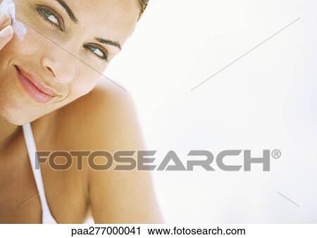 Woman applying sunscreen to face, close-up View Large Photo Image Stock Image - Woman applying sunscreen to face, close-up. Fotosearch