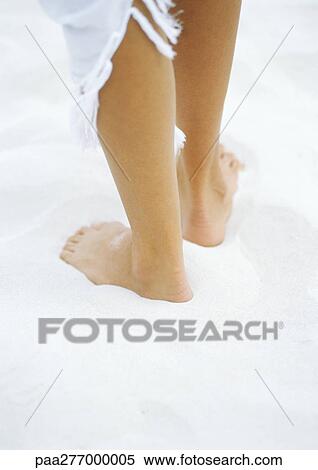 Woman standing barefoot on sand, lower part of legs, rear view View Large Photo Image Stock Photography - Woman standing barefoot on sand, lower part of legs, rear view. Fotosearch