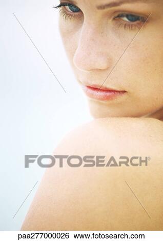 Young woman's face and shoulder, close-up View Large Photo Image Stock Photograph - Young woman's face and shoulder, close-up. Fotosearch