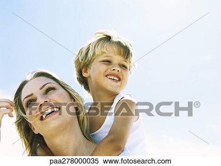 Boy and mother, boy behind mother with arms around her neck, portrait View Large Photo Image Stock Photography - Boy and mother, boy behind mother with arms around her neck, portrait. Fotosearch