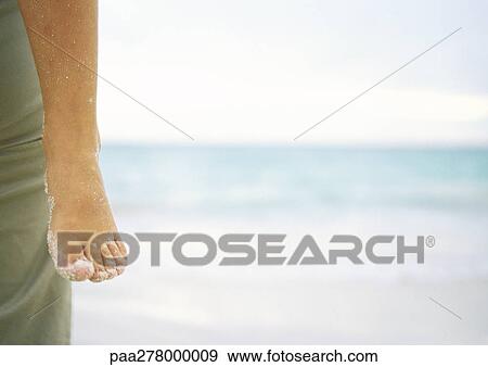 Child being held by parent on beach, close-up of sandy foot View Large Photo Image Stock Photo - Child being held by parent on beach, close-up of sandy foot. Fotosearch