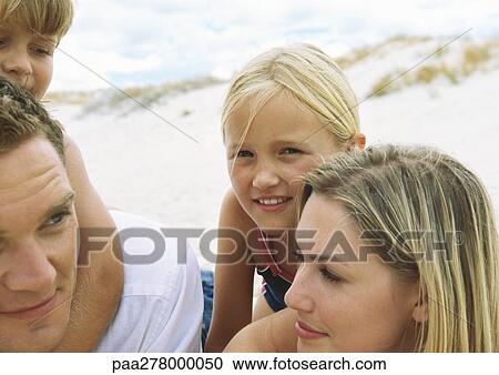 Stock Image - Family at beach, portrait. Fotosearch