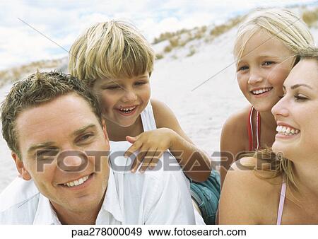 Stock Photo - Family at beach, portrait. Fotosearch