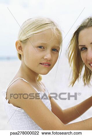 Stock Image - Girl and mother on beach, portrait. Fotosearch