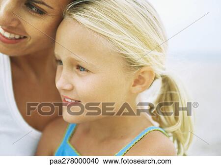 Stock Image - Girl and mother on beach, portrait. Fotosearch