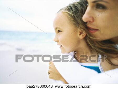 Girl and mother on beach View Large Photo Image Stock Image - Girl and mother on beach. Fotosearch