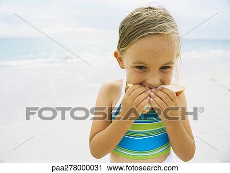 Girl eating sandwich on beach View Large Photo Image Stock Image - Girl eating sandwich on beach. Fotosearch