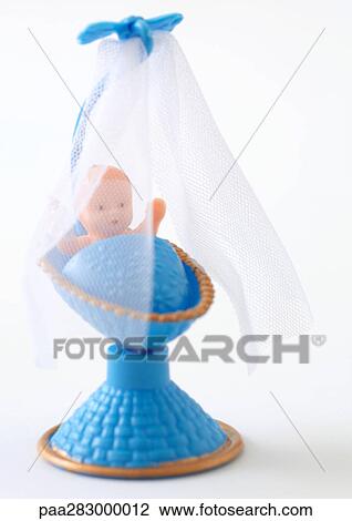 Plastic baby in blue crib View Large Photo Image Stock Image - Plastic baby in blue crib. Fotosearch