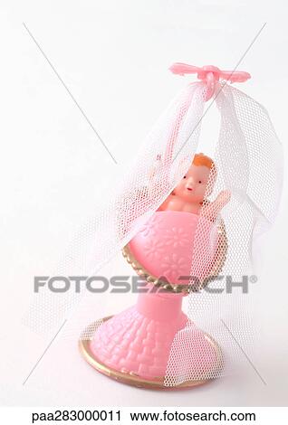 Plastic baby in pink crib View Large Photo Image Stock Image - Plastic baby in pink crib. Fotosearch