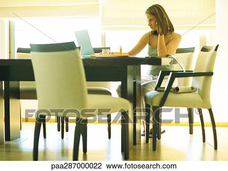 Female telecommuter working at table View Large Photo Image Stock Image - Female telecommuter working at table. Fotosearch