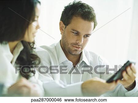 Young adults calculating View Large Photo Image Stock Photograph - Young adults calculating. Fotosearch