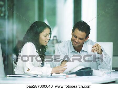 Young adults examining documents View Large Photo Image Stock Image - Young adults examining documents. Fotosearch
