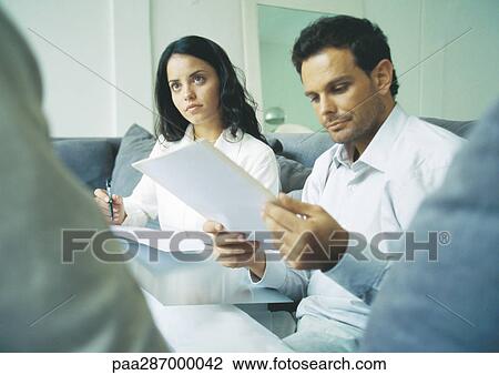 Young adults examining documents View Large Photo Image Stock Image - Young adults examining documents. Fotosearch
