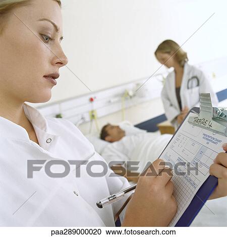 Doctors visiting patient View Large Photo Image Stock Image - Doctors visiting patient. Fotosearch