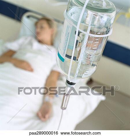 IV and female patient lying in hospital bed View Large Photo Image Stock Photograph - IV and female patient lying in hospital bed. Fotosearch