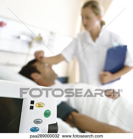 Nurse checking on patient View Large Photo Image Stock Image - Nurse checking on patient. Fotosearch