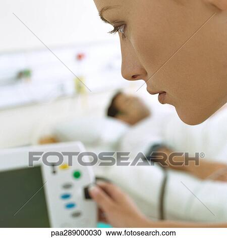 Nurse checking patient's monitor View Large Photo Image Stock Image - Nurse checking patient's monitor. Fotosearch