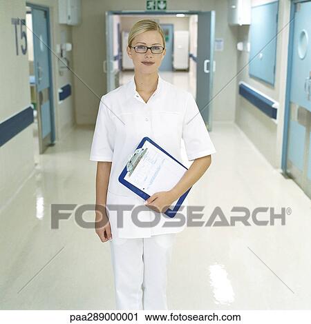 Nurse standing in hospital corridor View Large Photo Image Stock Image - Nurse standing in hospital corridor. Fotosearch