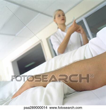 Nurse standing over patient in bed View Large Photo Image Picture - Nurse standing over patient in bed. Fotosearch