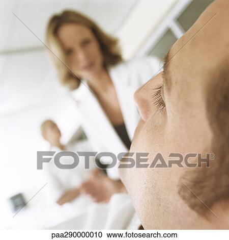 Doctor looking down at patient View Large Photo Image Stock Image - Doctor looking down at patient. Fotosearch