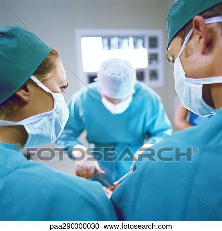 Doctors performing operation View Large Photo Image Stock Image - Doctors performing operation. Fotosearch