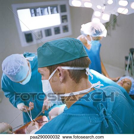 Stock Image - Doctors performing operation. Fotosearch
