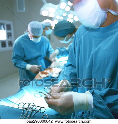 Doctors performing operation View Large Photo Image Stock Image - Doctors performing operation. Fotosearch