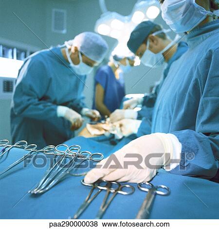Doctors performing operation View Large Photo Image Stock Photo - Doctors performing operation. Fotosearch