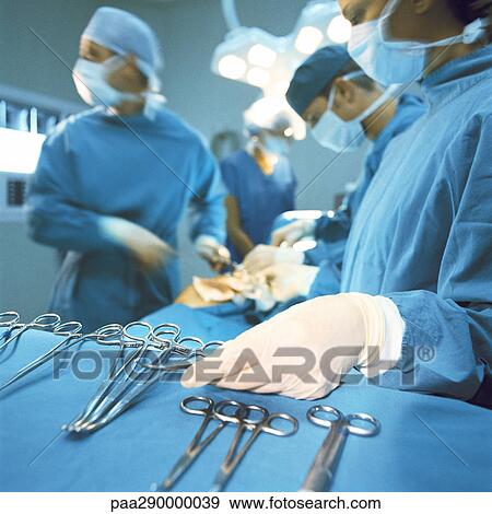 Doctors performing operation View Large Photo Image Stock Photo - Doctors performing operation. Fotosearch