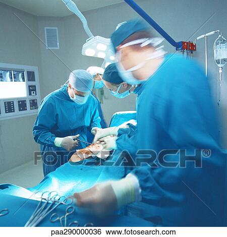 Doctors performing operation View Large Photo Image Stock Photograph - Doctors performing operation. Fotosearch