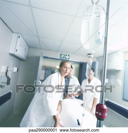 Medical team pushing patient on gurney View Large Photo Image Stock Image - Medical team pushing patient on gurney . Fotosearch