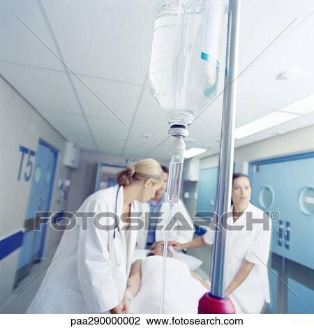 Medical team pushing patient on gurney View Large Photo Image Stock Image - Medical team pushing patient on gurney. Fotosearch