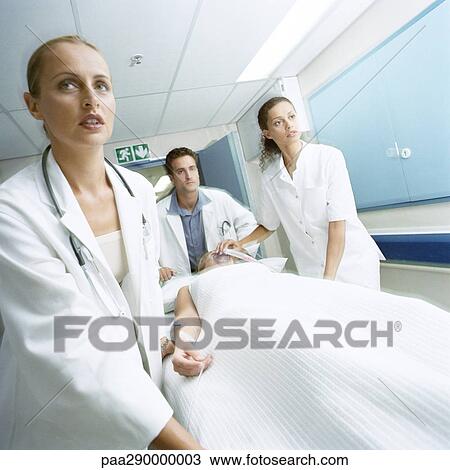 Medical team pushing patient on gurney View Large Photo Image Stock Image - Medical team pushing patient on gurney. Fotosearch