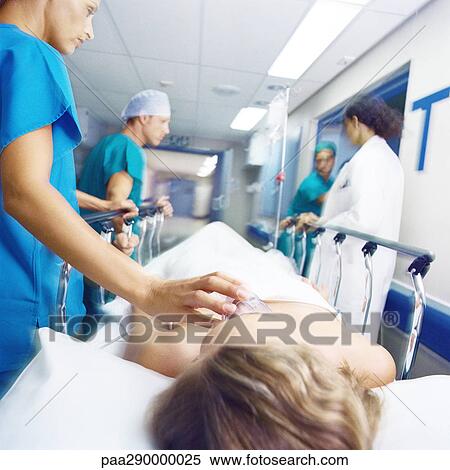 Medical team pushing patient on gurney View Large Photo Image Stock Photography - Medical team pushing patient on gurney . Fotosearch