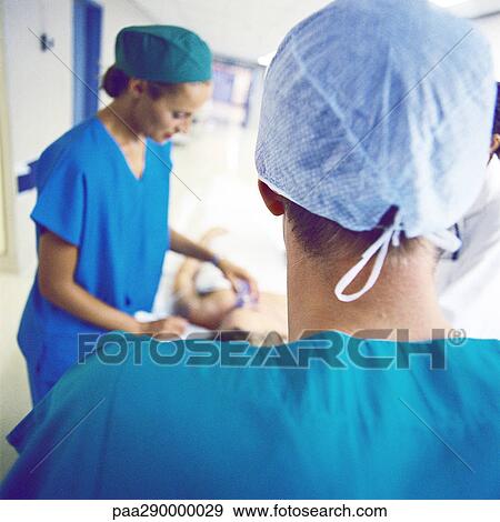 Medical team with patient on gurney View Large Photo Image Stock Photo - Medical team with patient on gurney . Fotosearch