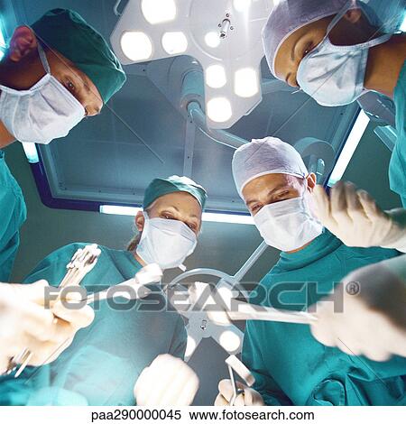 Surgical team preparing to operate, low angle view View Large Photo Image Stock Photography - Surgical team preparing to operate, low angle view. Fotosearch
