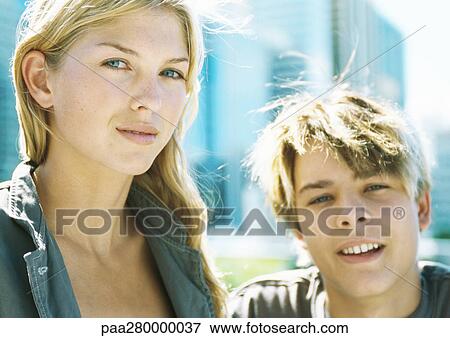 Teenage boy and young woman, looking at camera View Large Photo Image Stock Photo - Teenage boy and young woman, looking at camera. Fotosearch