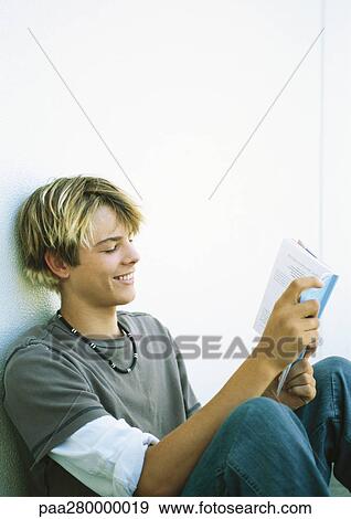 Teenage boy reading book View Large Photo Image Stock Photo - Teenage boy reading book. Fotosearch