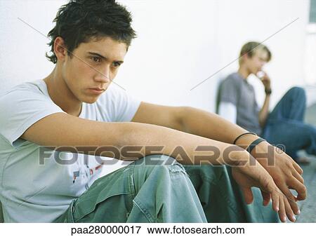 Teenage boys sitting on ground View Large Photo Image Stock Photo - Teenage boys sitting on ground. Fotosearch