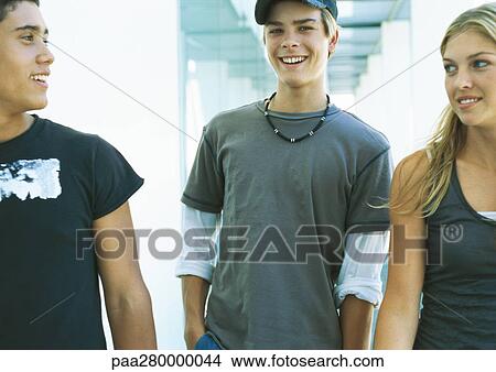 Three young people together, smiling View Large Photo Image Picture - Three young people together, smiling. Fotosearch