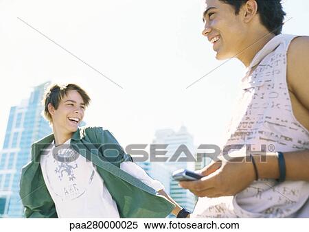 Two teenage boys in city setting View Large Photo Image Stock Photography - Two teenage boys in city setting. Fotosearch