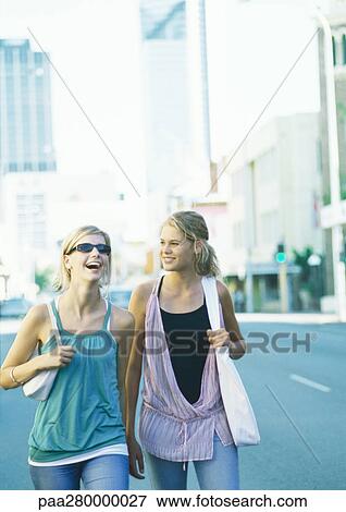Two teenage girls walking in city View Large Photo Image Stock Photo - Two teenage girls walking in city. Fotosearch