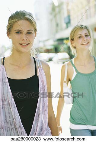 Two teenage girls walking in city View Large Photo Image Stock Photo - Two teenage girls walking in city. Fotosearch