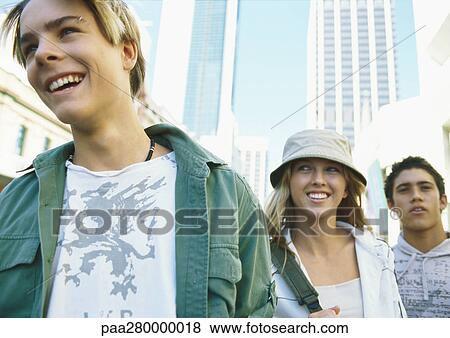 Stock Photo - Young people together in city, low angle view. Fotosearch