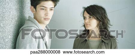 Stock Photo - Young couple, young man looking away. Fotosearch