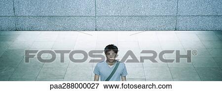 Young man in urban setting View Large Photo Image Stock Photo - Young man in urban setting. Fotosearch