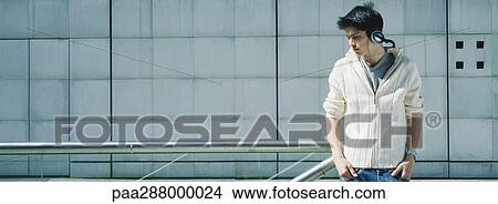 Young man wearing headphones View Large Photo Image Picture - Young man wearing headphones. Fotosearch