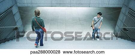 Young people in subway entrance View Large Photo Image Stock Photo - Young people in subway entrance. Fotosearch