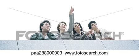 Stock Image - Young people looking up, low angle view. Fotosearch
